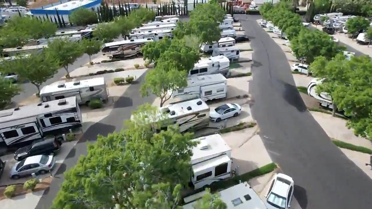 Aerial view of tree-lined RV sites at The Californian RV Resort