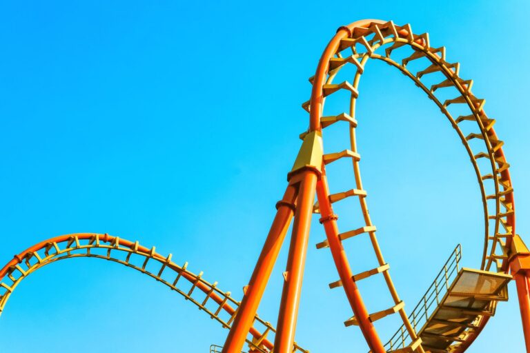 Roller coaster track against a blue sky