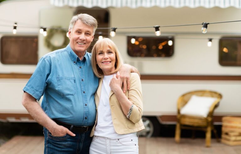 Couple relaxing beside their motorhome at an RV park