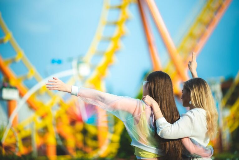 Friends laughing together on a theme park day trip